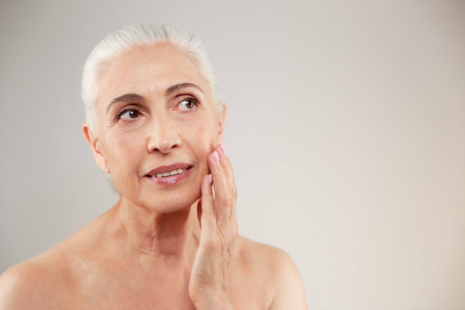 Older woman with healthy, glowing skin maintained through peptide treatments, symbolizing anti-aging benefits and wellness.