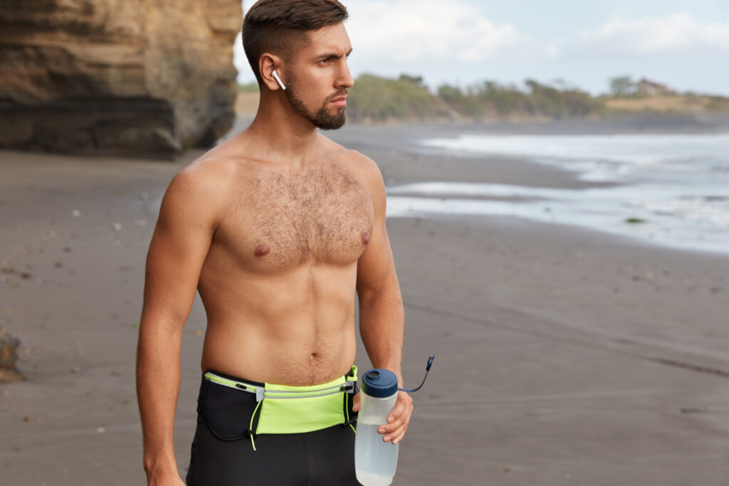 Fit man at the beach with gym clothes