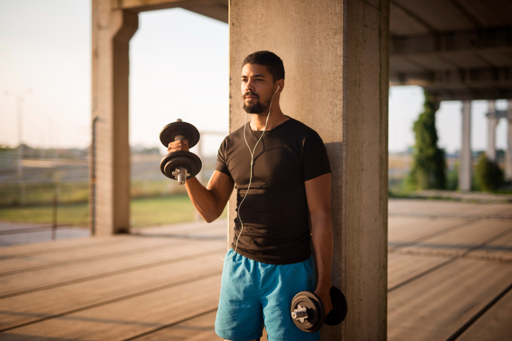 Man with dumbells working out on the street