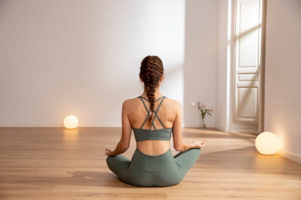 Woman doing yoga in her house with gym clothes