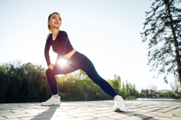Woman stretching her legs on the street