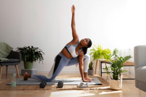 Woman performing a yoga-inspired mobility and strength exercise at home, supporting metabolic health, flexibility, functional fitness, and advanced wellness-focused lifestyle therapy.